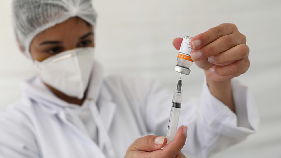 A nurse prepares a Covid-19 vaccine