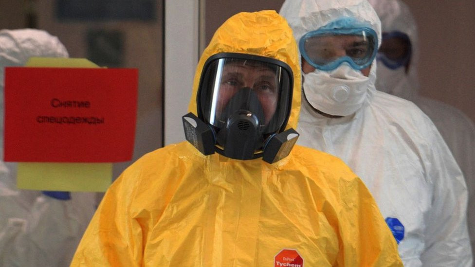 Vladimir Putin wearing personal protection equipment