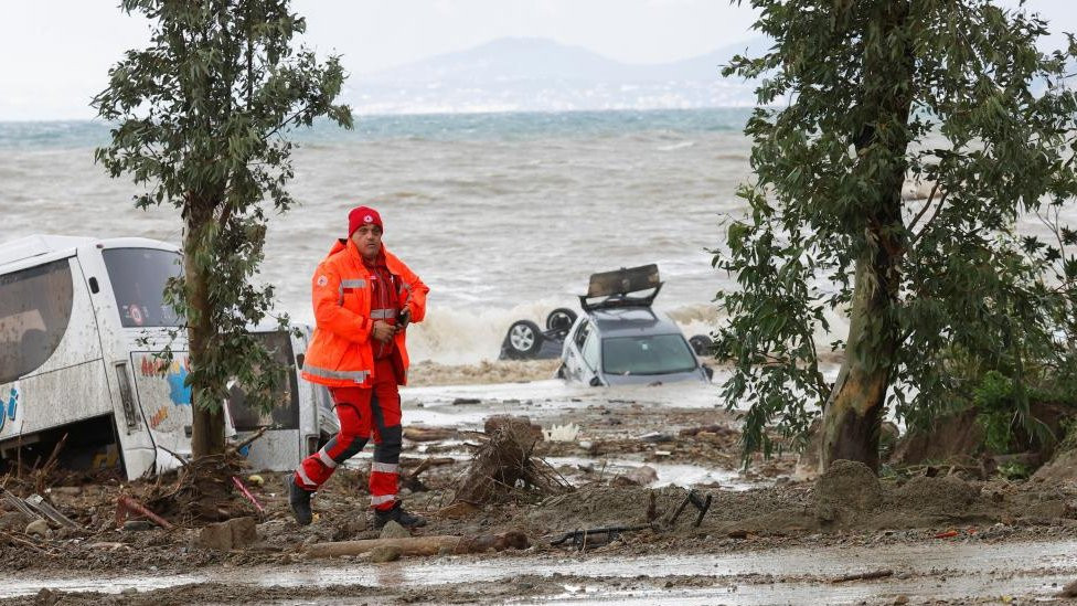 Cars are seen in the sea following the landslide on Ischia