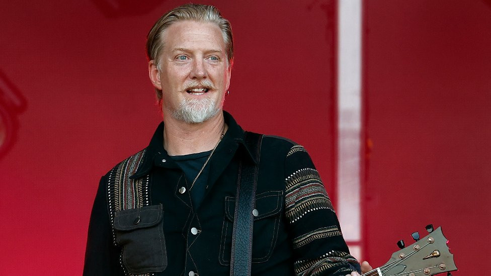 Josh Homme holding guitar