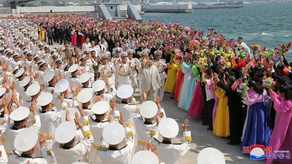 People attend what North Korean state media report was the country's launching ceremony for a new tactical nuclear attack submarine