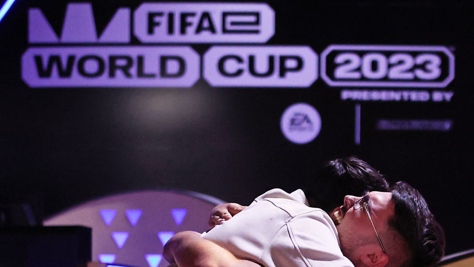 Hugging competitors at the FIFAe World Cup 2023 on July 18, 2023 in Riyadh, Saudi Arabia