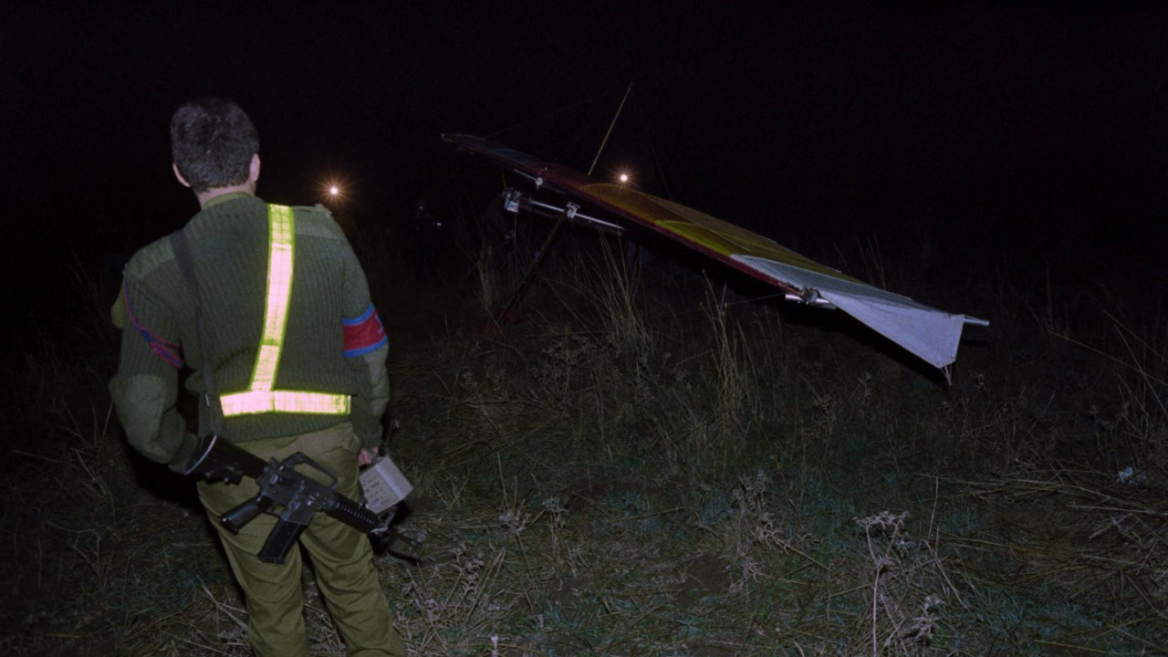 An Israeli soldier looks at the motorized hang glider used in a suicide attack on 26 November 1987, at a military camp near Kiryat Shmona in northern Israel, where six Israeli soldiers were killed and seven wounded
