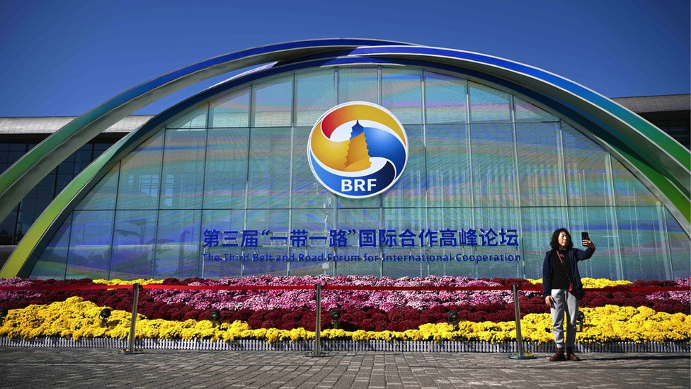 A woman takes a selfie in front of an installation for the third Belt and Road Forum for International Cooperation, beings held in Beijing on 17 and 18 October in Beijing