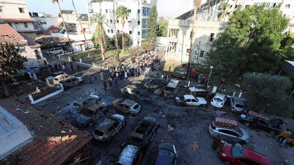 A view shows an area of Al-Ahli hospital following the blast. Burnt out cars can be seen in the foreground