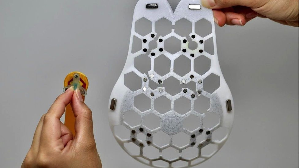 The small ultrasound scanner can fit in one of six slots to take an image of the breast