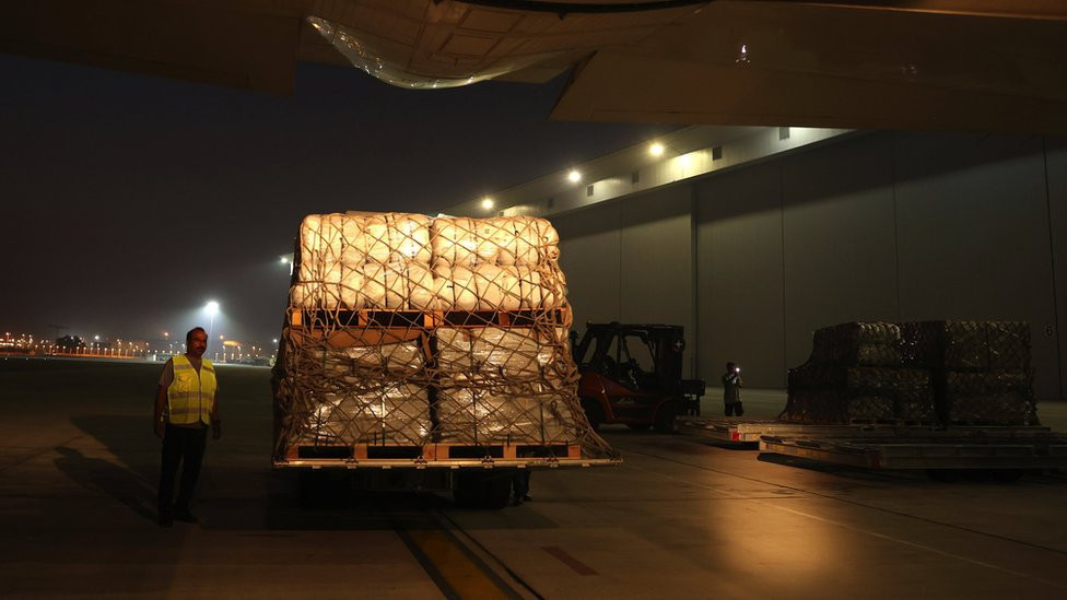 Workers load an airplane heading to Egypt with humanitarian aid and relief goods to the Gaza Strip, at Dubai International Airport, United Arab Emirates, 19 October 2023. The International Humanitarian City (IHC) based in Dubai is sending humanitarian aid and relief goods to Gaza. The Israeli government said on 18 October it will not prevent humanitarian aid entering Gaza from Egypt