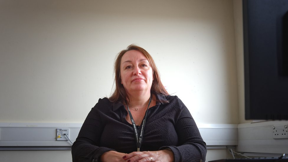 Michelle McHugh, the deputy bureau manager, sitting in front of a desk