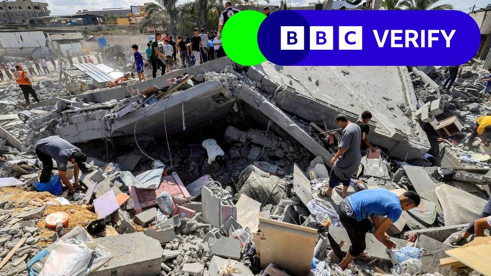 People searching through rubble in aftermath of strike in Khan Younis