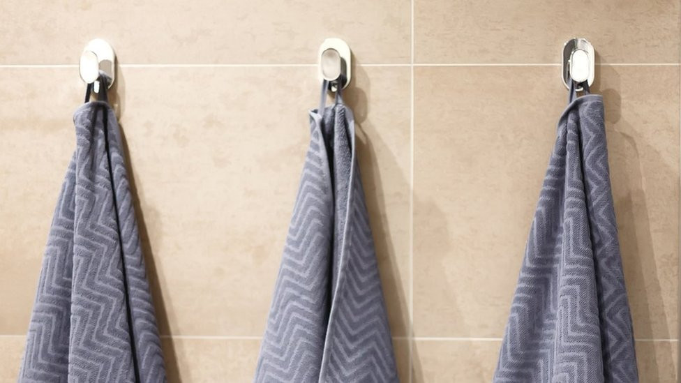 Towels hanging on normal bath hooks (stock image)