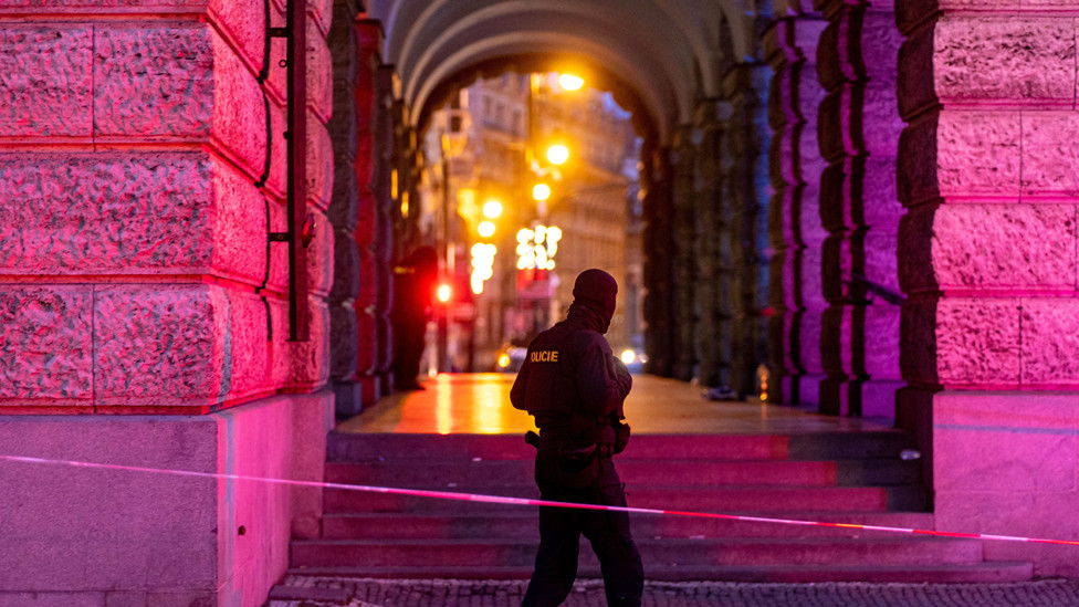 A police officer patrols following a mass shooting at one building of the Charles University in central Prague, Czech Republic, 22 December 2023.