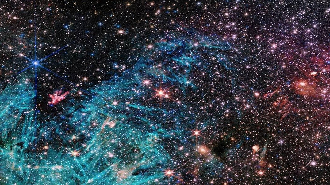 A ingle image shows half a million stars with bright cyan-coloured patches of excited hydrogen gas