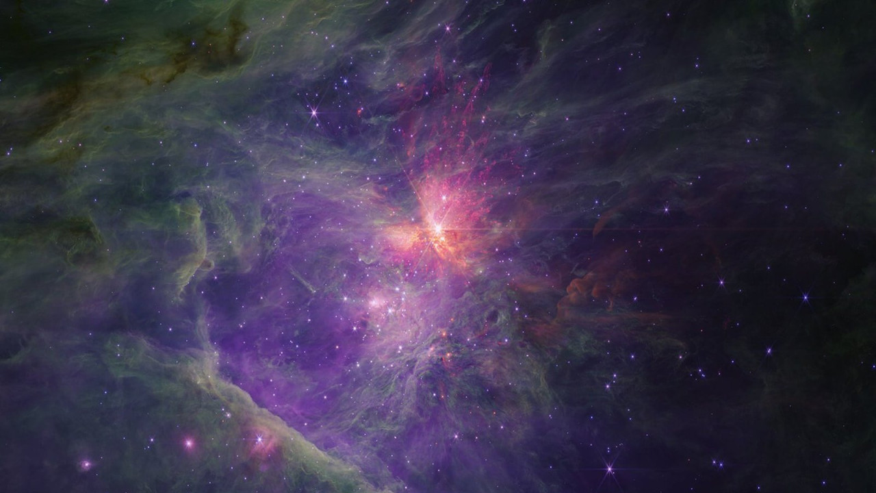 Bright orange light surrounds the Orion nebula, which can be seen as a smudge with the naked eye