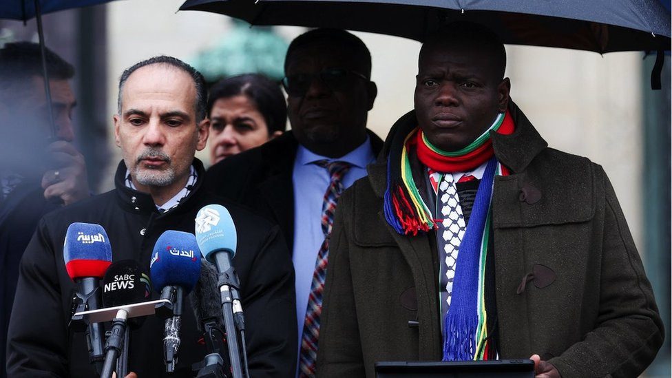 South Africa's Minister of Justice Ronald Lamola looks on, as a member of South African delegation addresses the media near the International Court of Justice (ICJ), on the day judges hear a request for emergency measures by South Africa to order Israel to stop its military actions in Gaza, in The Hague, Netherlands January 12, 2024. REUTERS/Thilo Schmuelgen