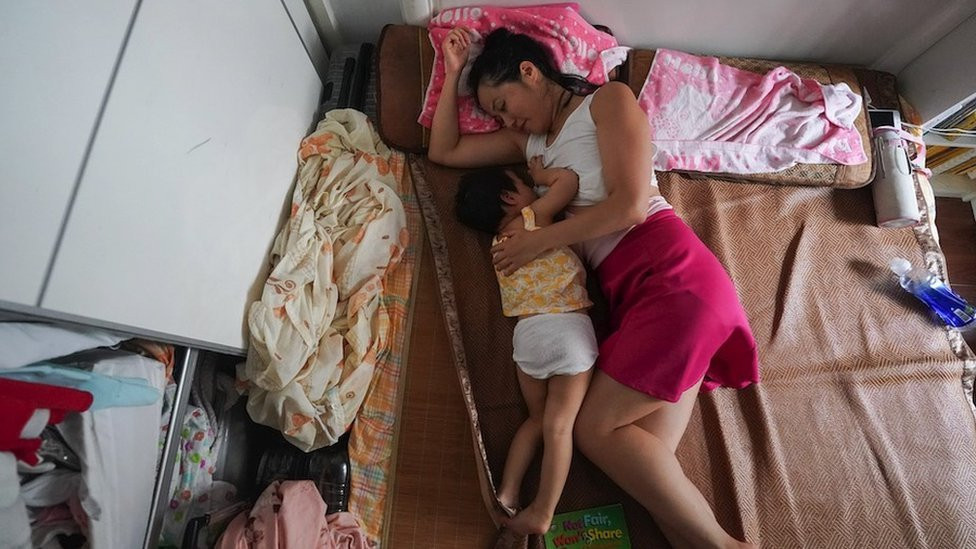 This photo taken on 5 August 2020 shows Chao Anya feeding her child at their home in Shanghai