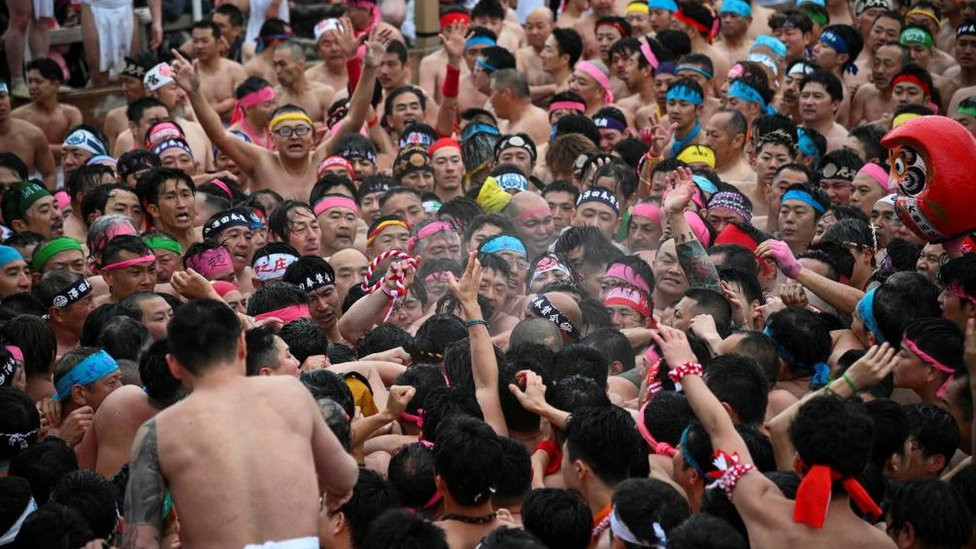 Participants take part in a ritual event of naked festival at Owari Okunitama Shrine