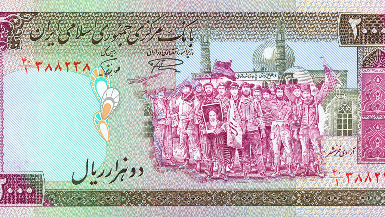 An old Iranian banknote depicts soldiers who fought at Iran-Iraq war holding Ayatollah Khomeini's picture