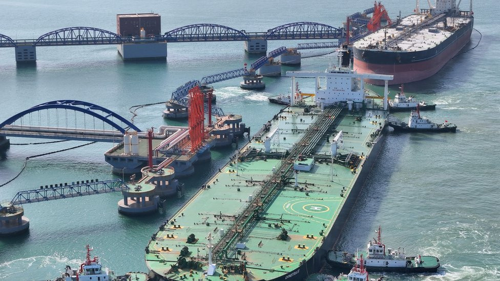 A very large oil tanker is being assisted by a tugboat as it berths at Yantai Port's 300,000-ton crude oil terminal in Yantai, Shandong Province, China, on April 25, 2024.