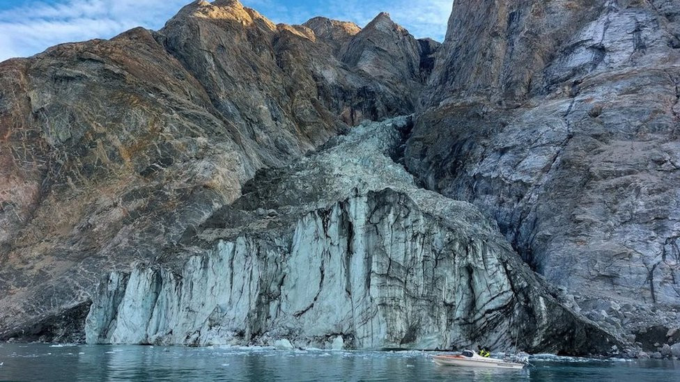 Mali istraživački čamac ispred glečera u fjordu na Grenlandu