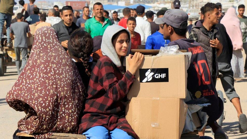 kamioni sa humanitarnom pomoći, humanitarna pomoć za Gazu, glad u gazi, ljudi u gazi nose pomoć
