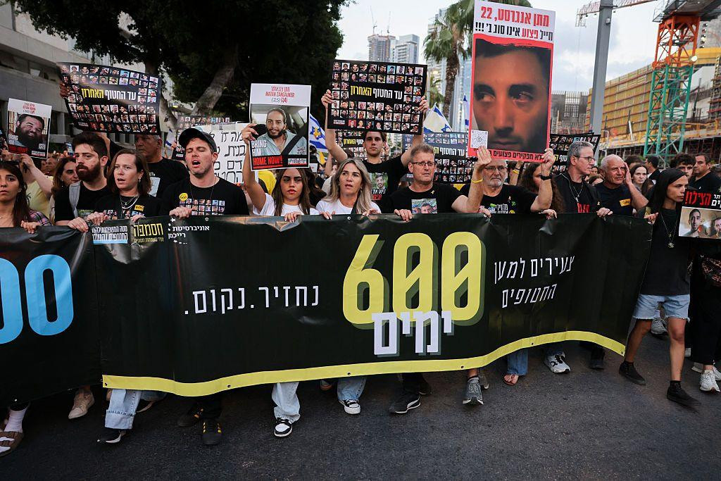 
                    Relatives and supporters of Israeli hostages held captive in the Gaza Strip since October 7 hold their portraits during a protest at Hostages Square in Tel Aviv on 28 May