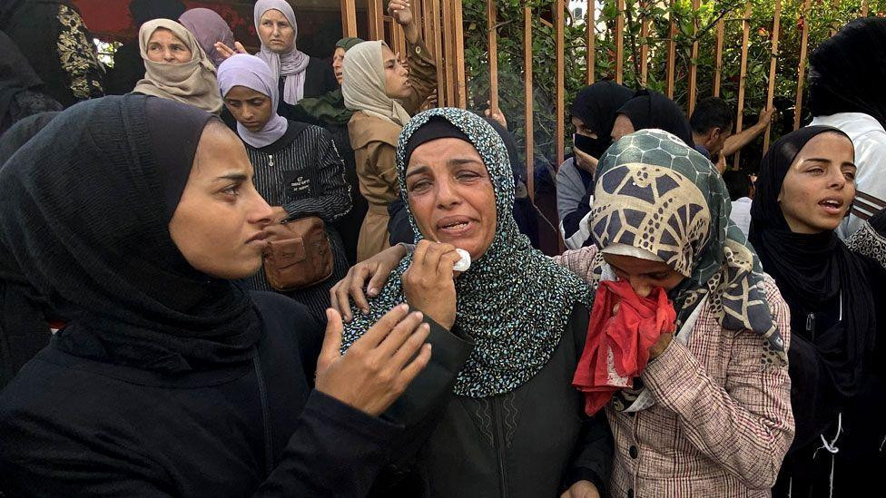 
                    Mourners weep during the funeral of Palestinians killed in Israeli strikes on the southern Gaza Strip the previous day, outside the Nasser Hospital in Khan Yunis on July 