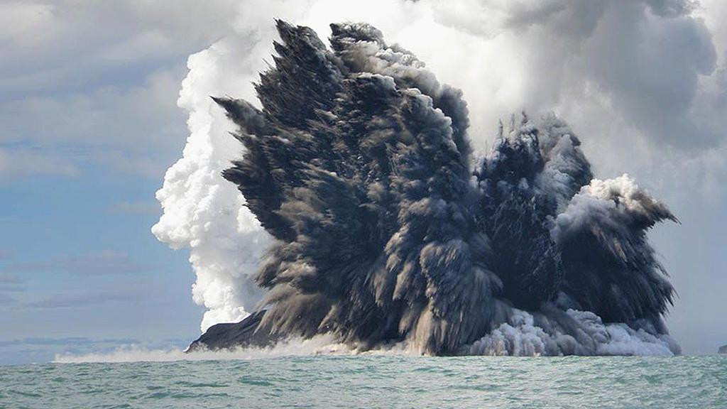 
                    The photo shows the eruption of an underwater volcanoes. The eruption could be seen above sea level. A huge plume of black and white smoke is at the centre of the photo. 
